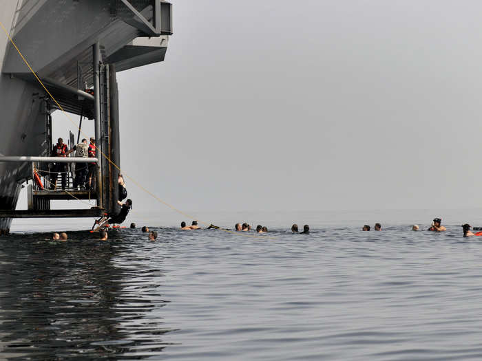 Sailors assigned to the USS Carl Vinson swim during a swim call in the Arabian Sea.