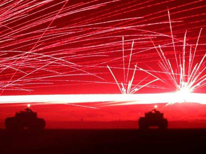 Tracer bullets ricochet off their targets as Japanese Ground Self-Defence Force tanks fire their machine guns, during a night session of an annual training exercise.