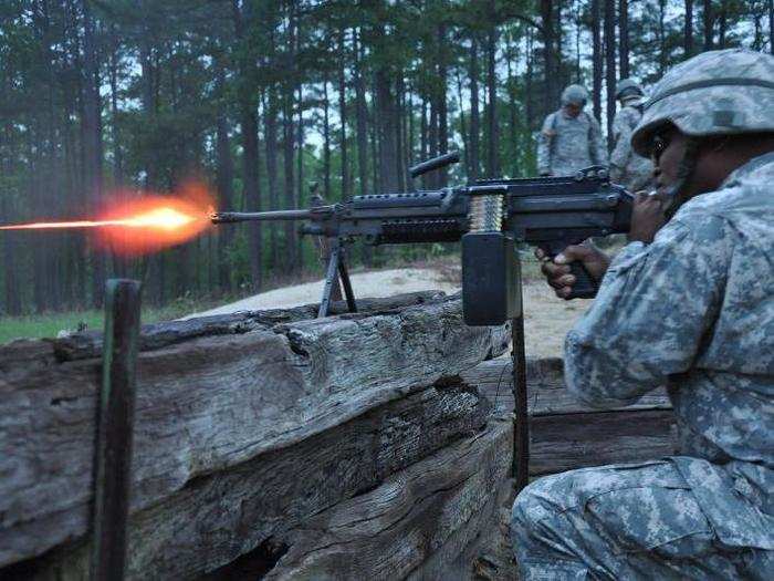 A soldier from the District of Columbia National Guard fires tracer rounds from an M249 machine gun, during crew-served weapon night fire training.