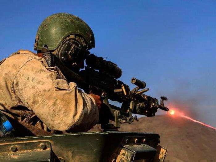 Gunnery Sgt. Dragos Coca, from the 15th Marine Expeditionary Unit, engages targets during a desert survival and tactics course.