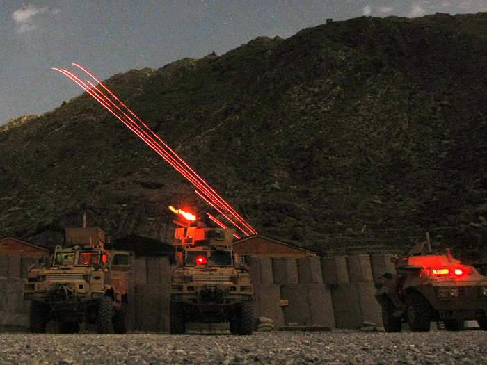 Machine gun tracer rounds illuminate the sky over the US Army