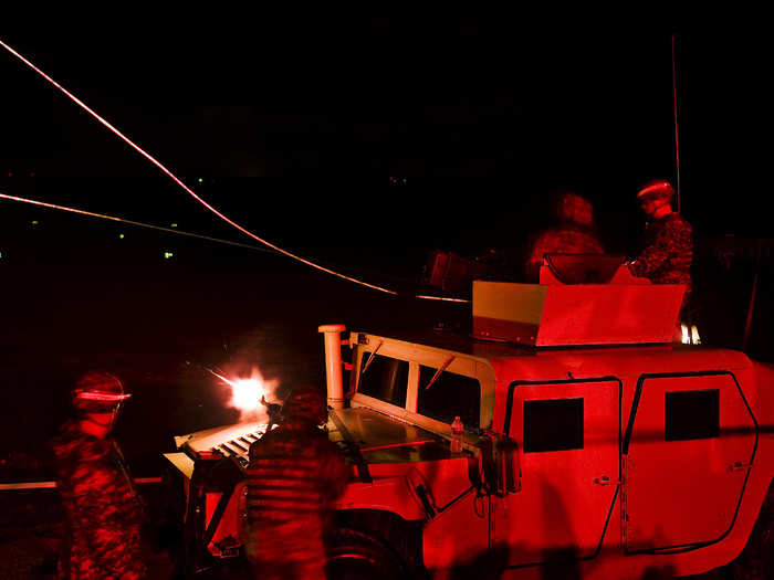 US military police conduct a night fire exercise.