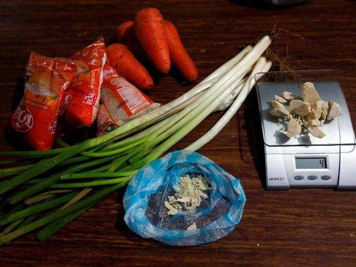 Rice and vegetables lie next to coca paste worth $8,000 Colombian pesos at a local store in Guyabero Region, Guaviare, Colombia.