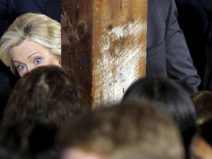 Peek-a-boo: Hillary sizes up her audience at a campaign launch party at Carter Hill Orchard in Concord, New Hampshire, on June 15, 2015.