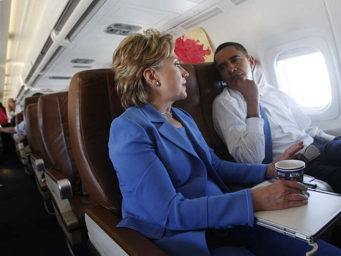 Then US Democratic presidential candidate Barack Obama listens to Hillary Clinton on a plane after leaving Washington June 27, 2008.