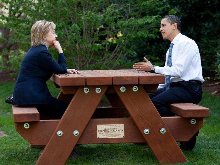 President Barack Obama and Secretary of State Hillary Rodham Clinton speak together sitting at a picnic table April 9, 2009, on the South Lawn of the White House.