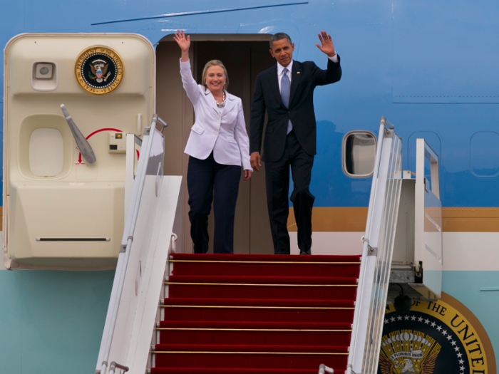 President Barack Obama and Secretary of State Hillary Clinton wave as they arrive at Yangon International airport during his historical first visit to the country on November 19, 2012 in Yangon, Myanmar.