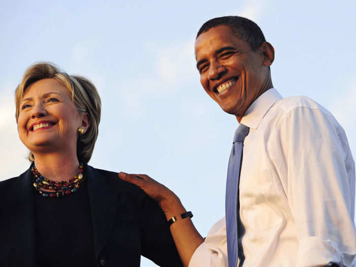 Hillary Clinton and Barack Obama share a smile for photographers.