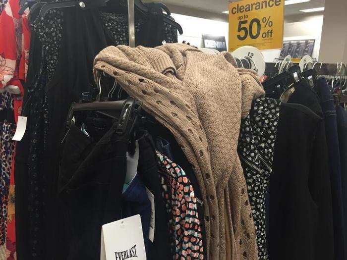 Clothing is haphazardly strewn on racks.