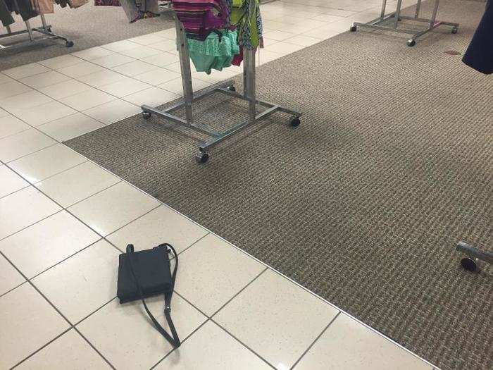 A bag for sale lays on the ground.