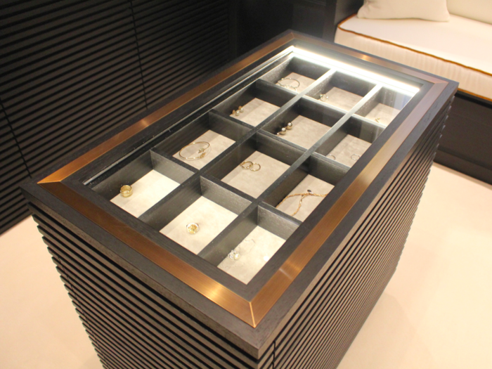 In the centre of the room is a display cabinet for cuff links, watches, and jewellery.