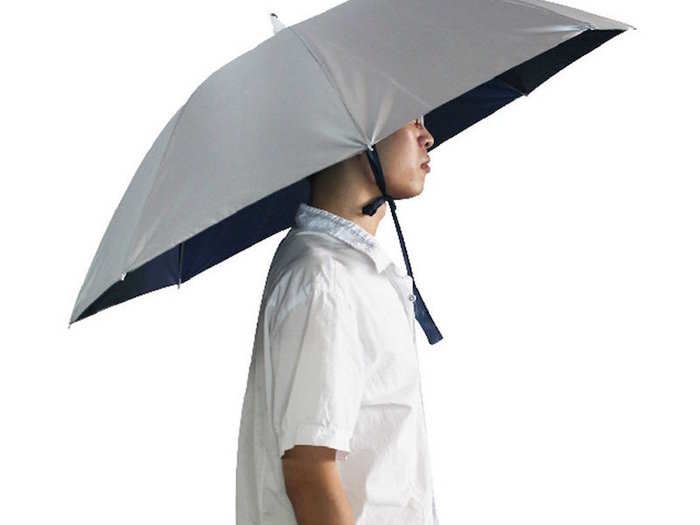 Instead of trying to hold your umbrella while lugging your bags, attach it to your head.