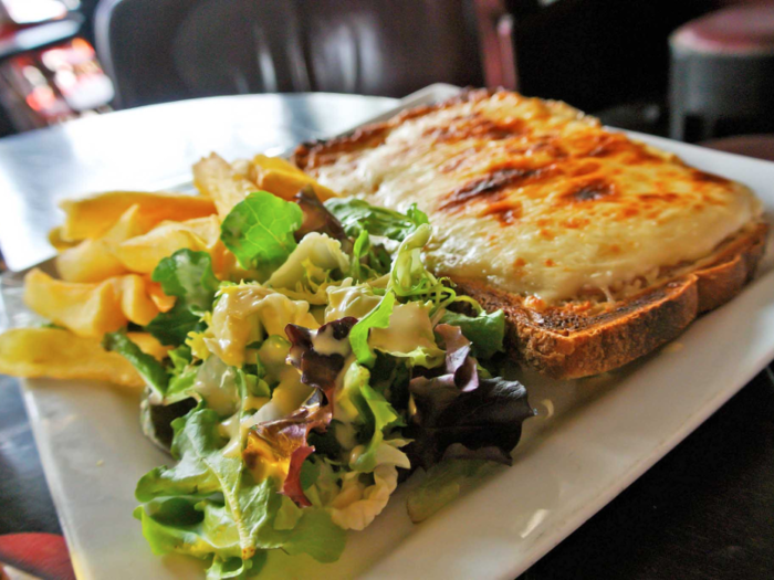 The French version of a grilled cheese sandwich, the croque-monsieur features jambon (ham) and melted gruyère cheese on the inside, with rich béchamel sauce oozing out all over the sandwich.