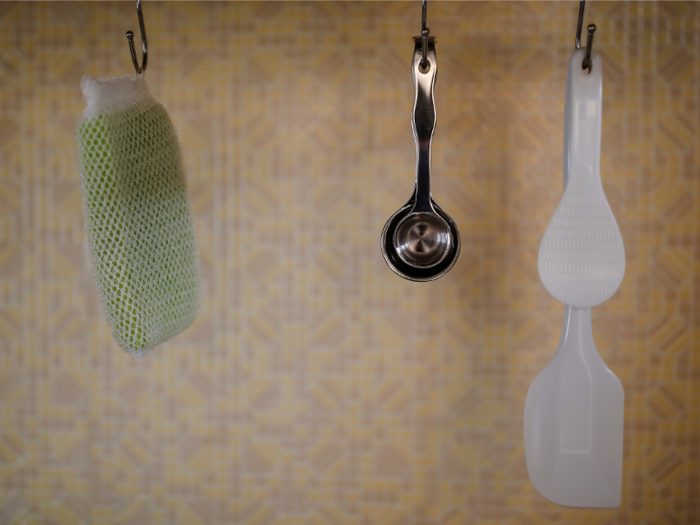 Hanging objects on simple hooks is a clean, popular storage strategy among minimalists.