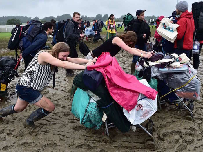 Many attendees are having to push their belongings through muddy fields, and surely regret packing heavily for the five-day festival.