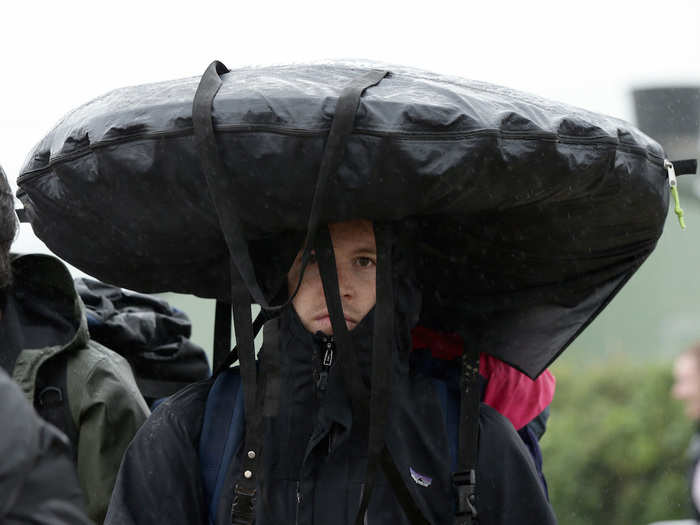 Meanwhile, some people are carrying their things on their heads to avoid the sludge, like this man...