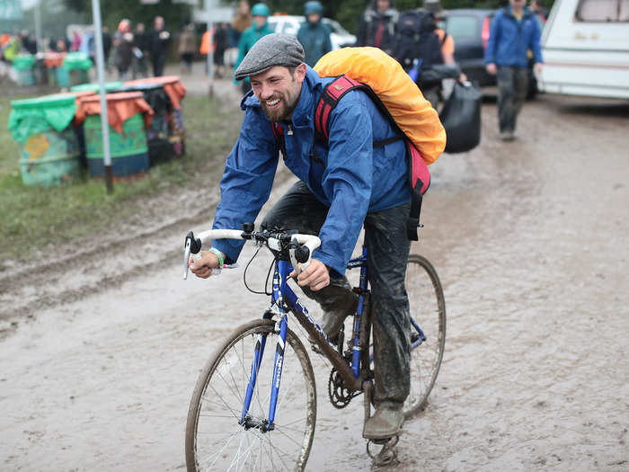 Like many others, this man cycling through slippery fields is covered in mud.