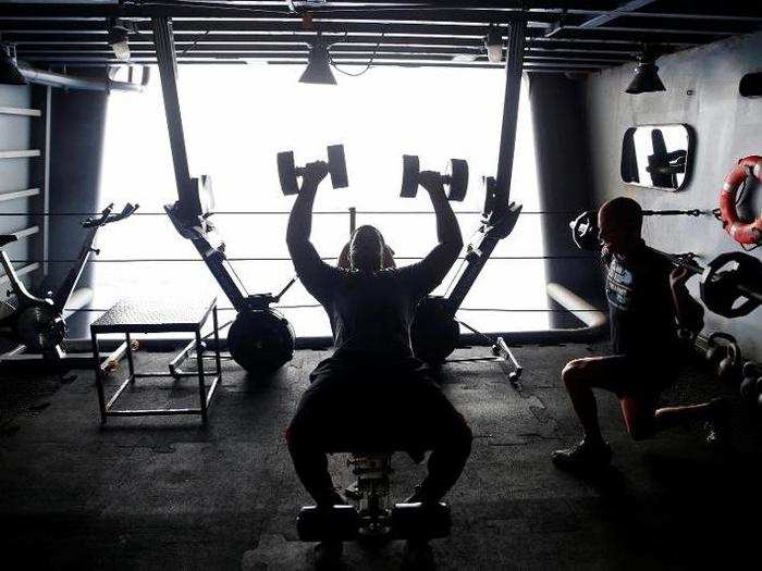 US Navy sailors work out on the USS Harry S. Truman aircraft carrier in the eastern Mediterranean Sea, June 14, 2016.