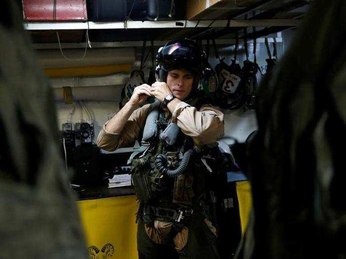 Navy F/A-18 pilot Commander Higgins from the VFA-83 Squadron also known as the "Rampagers" gets ready before a mission, on the USS Harry S. Truman aircraft carrier, in the eastern Mediterranean Sea, June 15, 2016.