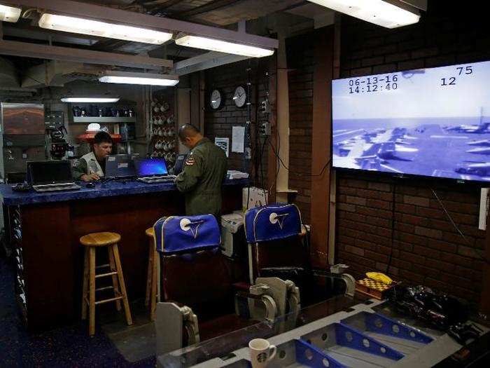 Pilots with the VAW-117 "Wallbangers" Airborne Command squadron wait in their room on board the USS Harry S. Truman aircraft carrier in the eastern Mediterranean Sea, June 13, 2016.