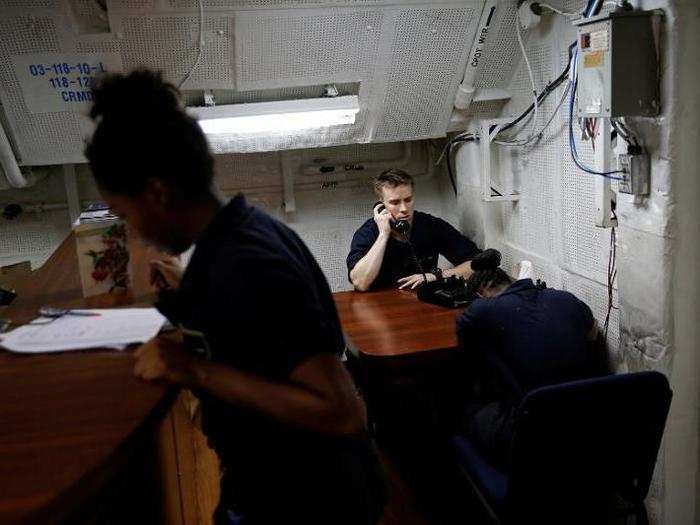 US Navy sailors use phones on board the USS Harry S. Truman aircraft carrier in the eastern Mediterranean Sea, June 14, 2016.