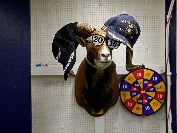 Hats are seen on an animal bust on the USS Harry S. Truman aircraft carrier in the eastern Mediterranean Sea, June 15, 2016.