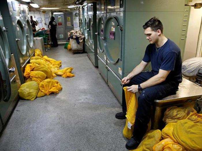 A US Navy sailor works in the laundry room of the USS Harry S. Truman aircraft carrier in the eastern Mediterranean Sea, June 14, 2016.