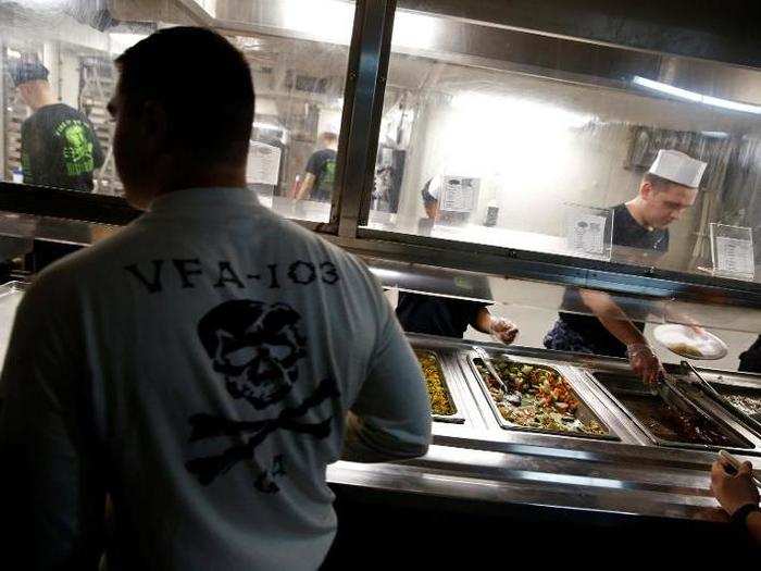 A US Navy sailor queues for food on board the USS Harry S. Truman aircraft carrier in the eastern Mediterranean Sea, June 14, 2016.