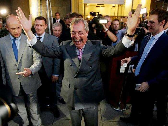 Nigel Farage, the leader of the UK Independence Party, celebrates and poses for photographers as he leaves a "Leave.EU" organization party for the British European Union membership referendum in London.