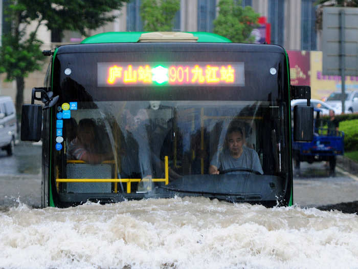 A bus goes through a flooded area in Jiujiang, Jiangxi Province, China.