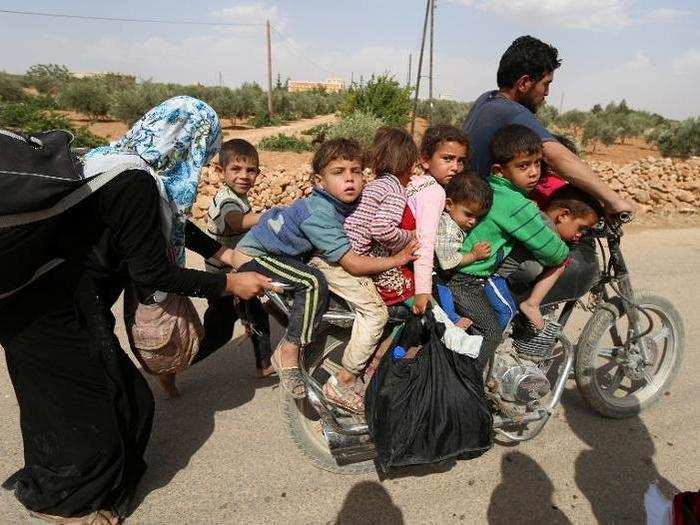 Civilians, who fled the violence in Manbij City, arrive in Aleppo Governorate, Syria.