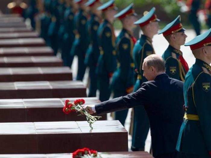 Russian President Vladimir Putin takes part in a wreath laying ceremony at the Tomb of the Unknown Soldier in Moscow, Russia, marking the 75th anniversary of the Nazi invasion of the Soviet Union.