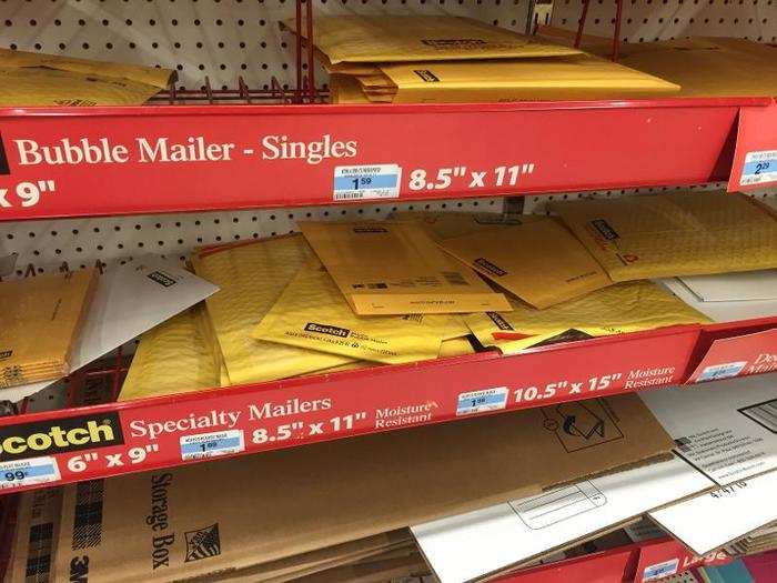 In the office supplies section, envelopes were strewn on the shelves in no particular order.