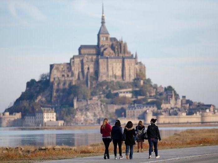 When tides are high, the island is inaccessible. But at low tide, tourists and pilgrims trek across the mudflats to the town.