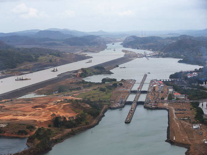 Part of the newly constructed Panama Canal expansion project runs to the left of the Miraflores locks along the Panama Canal.