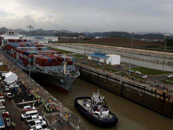 A cargo ship navigates through the locks prior to the grand opening.