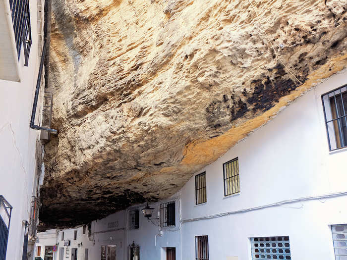 Visit Setenil de las Bodegas, a village in Andalucia, Spain, that was built into cliffs and where residents