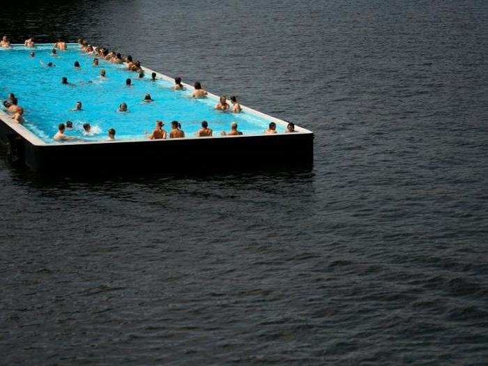 Take a dip in Badeschiff swimming pool in Berlin. The converted barge suspended on the river Spree is connected by a wooden footbridge to a bar and sun-loungers.