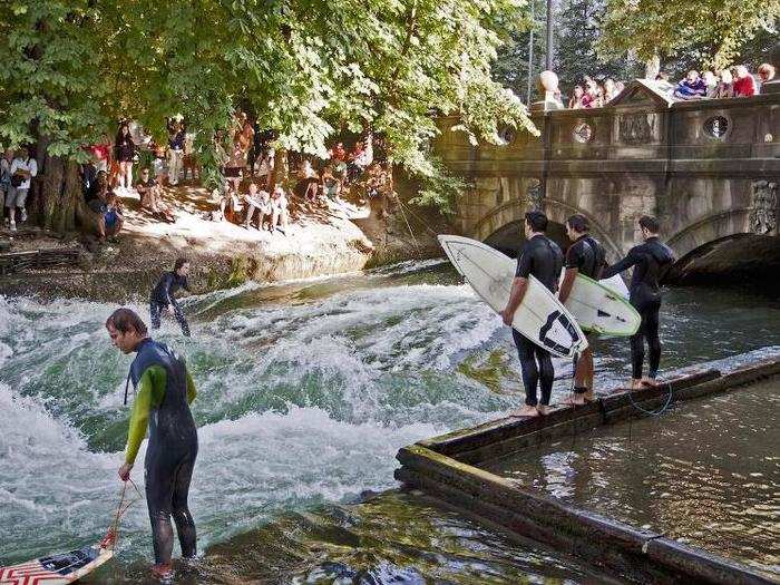 Go surfing in Munich, Germany, where city-based surfers take their boards to the Eisbach, a small man-made river in Englischer Garten park.