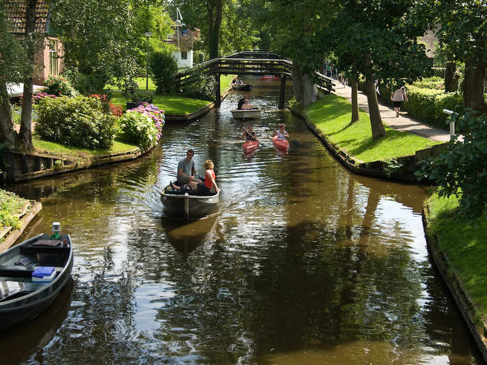 Rent a canoe in Giethoorn, a town without roads in the Netherlands where people get around by sailing along the canal, or walking or cycling along paths.