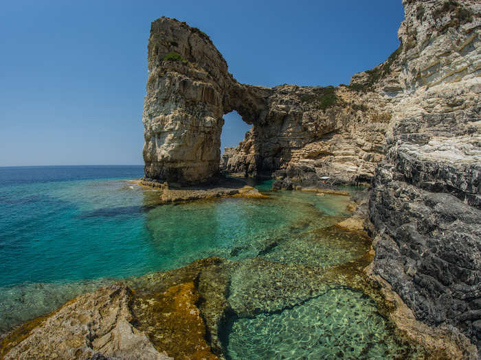 Bathe in the crystal-clear water of the Ionian sea off the Greek island of Paxi.