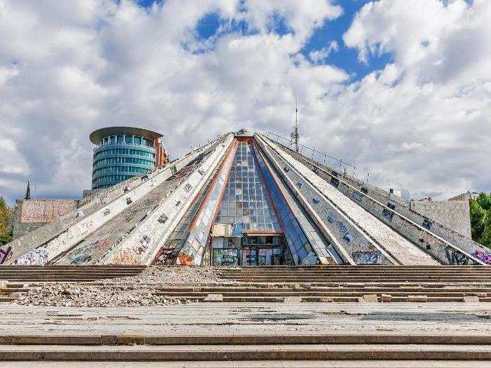 Marvel at the communist monument the Pyramid of Tirana in Albania.