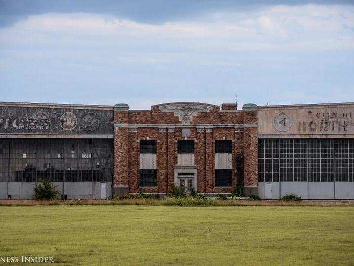 As the paint chips and fades away, the markings of past air services, airlines, and navy squadrons on the hangars reveal layers of history.