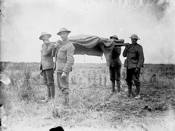 Canadian stretcher bearers carry the dead from a battlefield during the Battle of the Somme, France in July,1916.