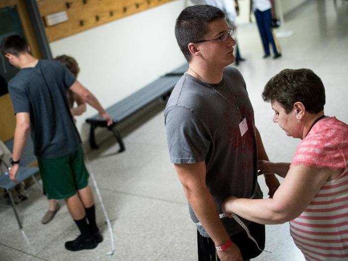 Here, a cadet candidate is fit for school issued clothing.