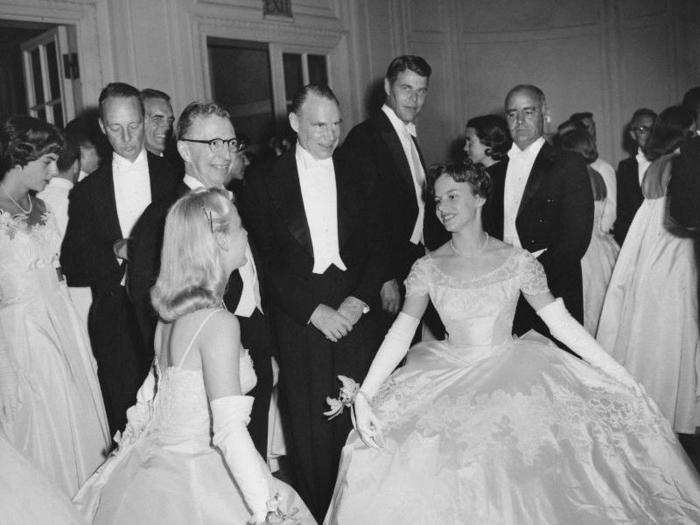 The 1953 book "The Glitter and the Gold" written by famous debutante Consuelo Vanderbilt Balsan, explored the stressful and exhausting world of debutante life leading up to the event. Here, Mary Henderson takes a curtsey at her coming out party in Boston, 1959.