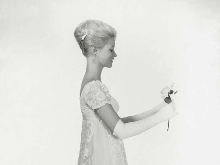 Mazie Cox poses for a picture in a dress which her mother designed for her for her ball.