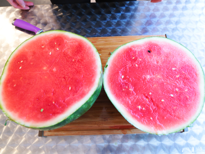 2. Slice the watermelon in half.