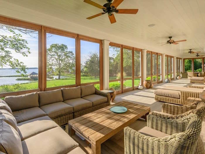 The waterfront vistas can be enjoyed from the spacious screened-in porch, which runs the entire length of the house and ensures insect-free relaxation.