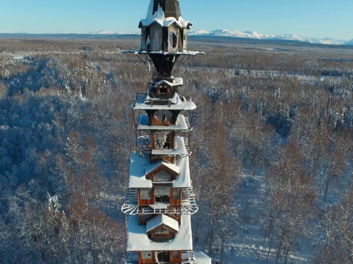 Observe the spindly "Dr. Seuss House" from a distance, as it lies on rural private property near the town of Talkeetna.